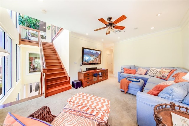 carpeted living room with ornamental molding and ceiling fan