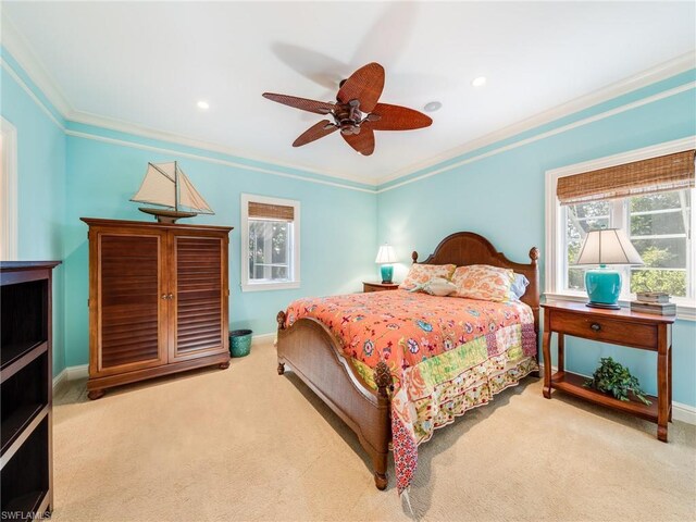 bedroom featuring light colored carpet, ceiling fan, and crown molding