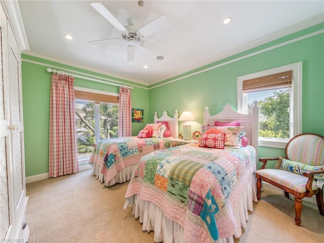 carpeted bedroom featuring crown molding and ceiling fan