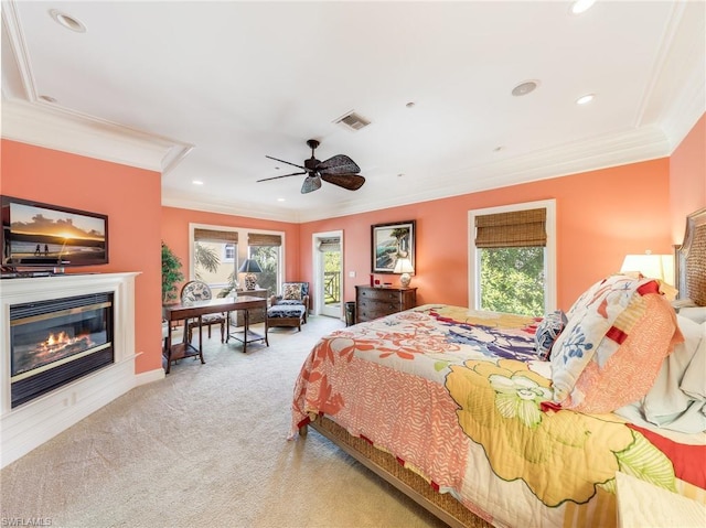 carpeted bedroom featuring ceiling fan and ornamental molding