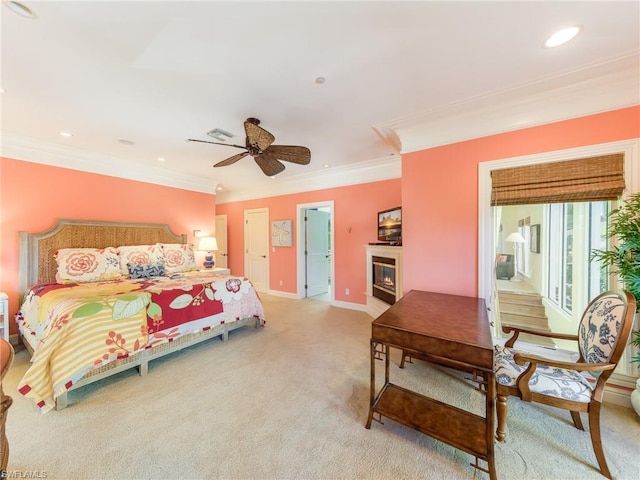 carpeted bedroom featuring ornamental molding and ceiling fan