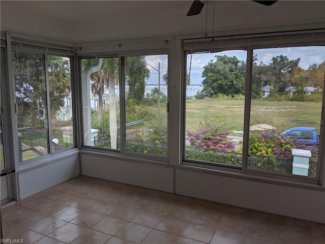 unfurnished sunroom with plenty of natural light and ceiling fan