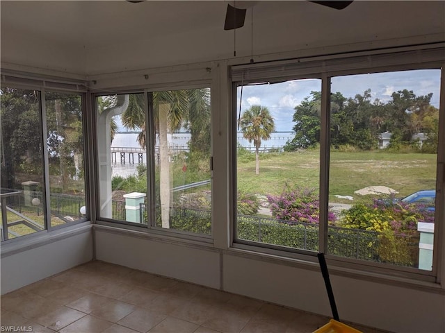 unfurnished sunroom with plenty of natural light and ceiling fan