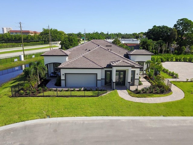 view of front of home with a front lawn and a garage