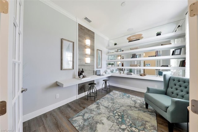 office with dark wood-type flooring and crown molding