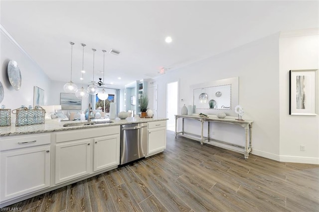 kitchen featuring decorative light fixtures, sink, white cabinets, light stone counters, and stainless steel dishwasher