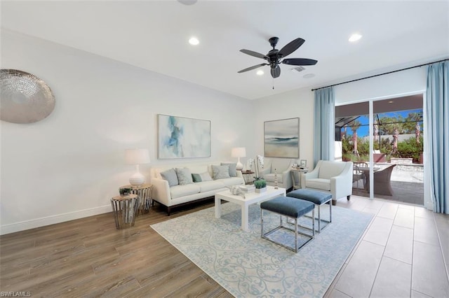 living room featuring light hardwood / wood-style flooring and ceiling fan