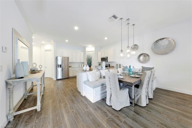 dining room featuring ornamental molding and hardwood / wood-style flooring