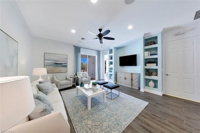 living room featuring dark hardwood / wood-style floors, built in features, and ceiling fan