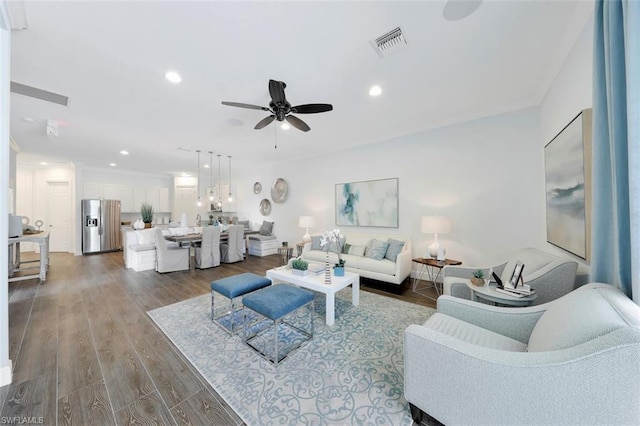 living room featuring dark hardwood / wood-style floors and ceiling fan