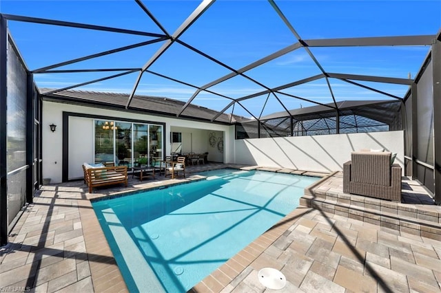 view of pool featuring glass enclosure and a patio area