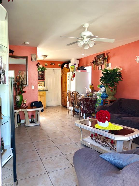 living room featuring ceiling fan and light tile flooring