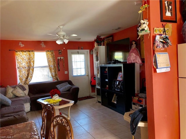 tiled living room with ceiling fan