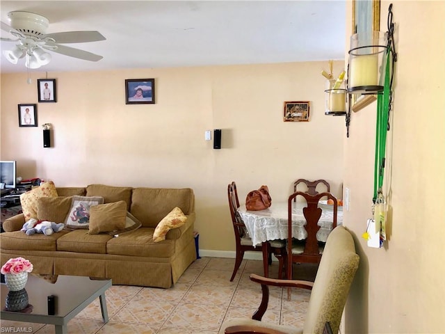 living room featuring light tile flooring and ceiling fan