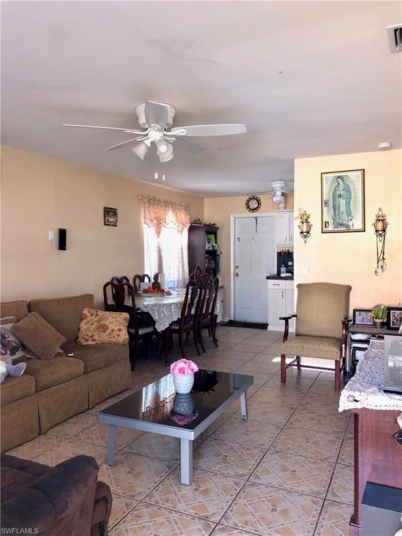 tiled living room featuring ceiling fan