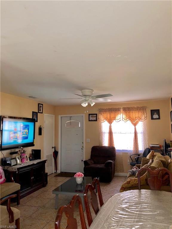 interior space featuring ceiling fan and light tile flooring