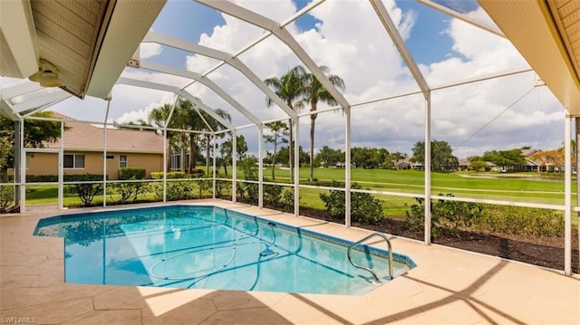 view of pool featuring a patio, a yard, and glass enclosure