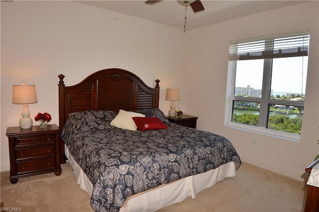 bedroom featuring light carpet and ceiling fan