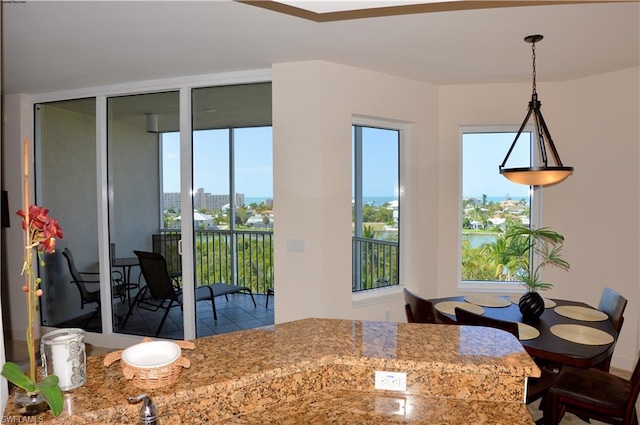 kitchen featuring pendant lighting and light stone counters