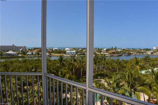 unfurnished sunroom featuring a water view