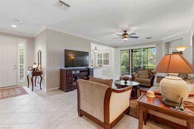 tiled living room with ornamental molding and ceiling fan