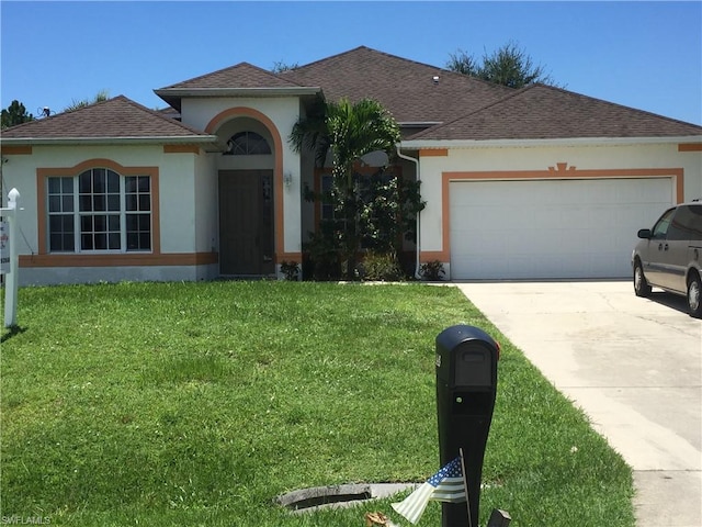 view of front of home with a front lawn and a garage