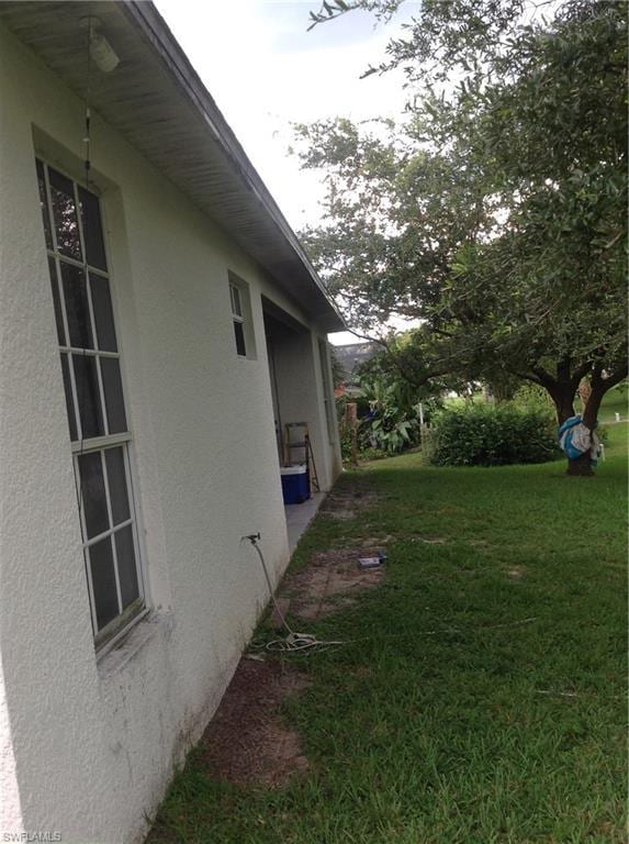 view of property exterior featuring a lawn