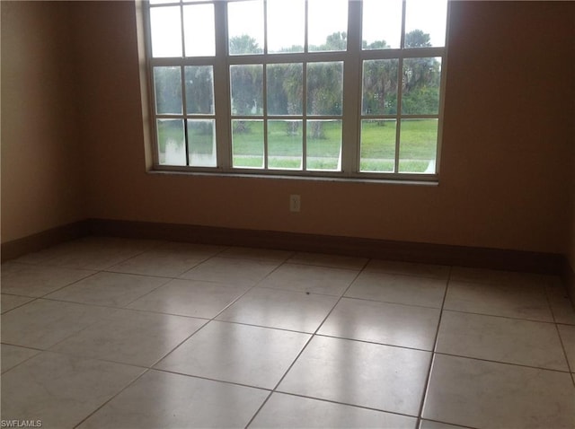 unfurnished room featuring light tile floors