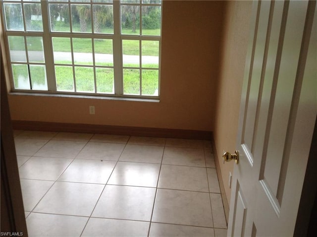 unfurnished room featuring light tile floors