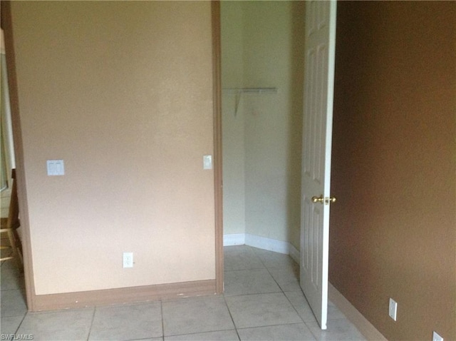 hall featuring light tile floors