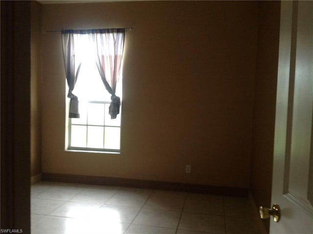 spare room with light tile floors