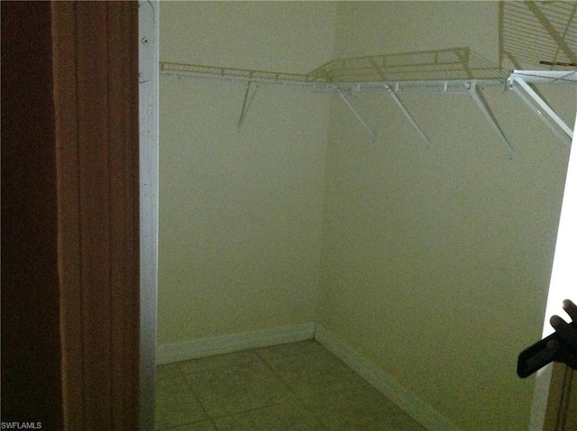 spacious closet featuring tile flooring