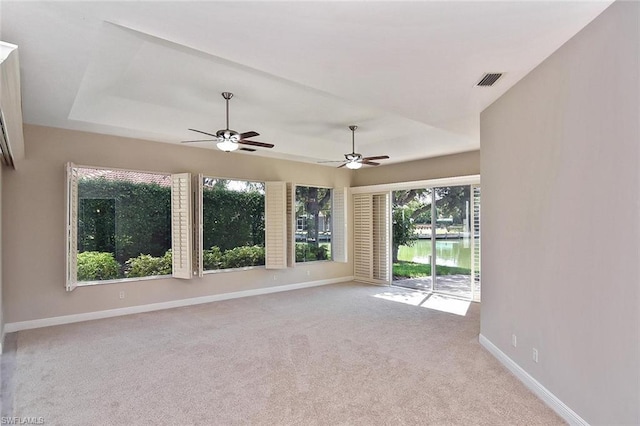 carpeted spare room with ceiling fan