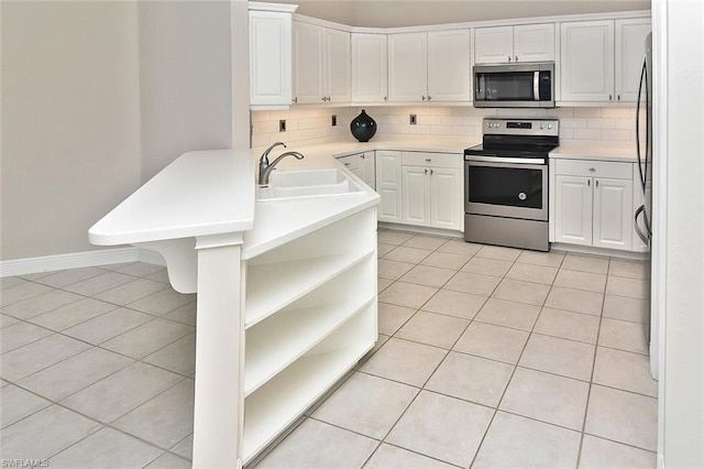 kitchen with backsplash, sink, stainless steel appliances, light tile floors, and white cabinets