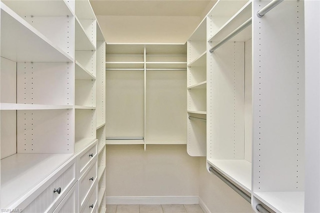 spacious closet featuring light tile floors