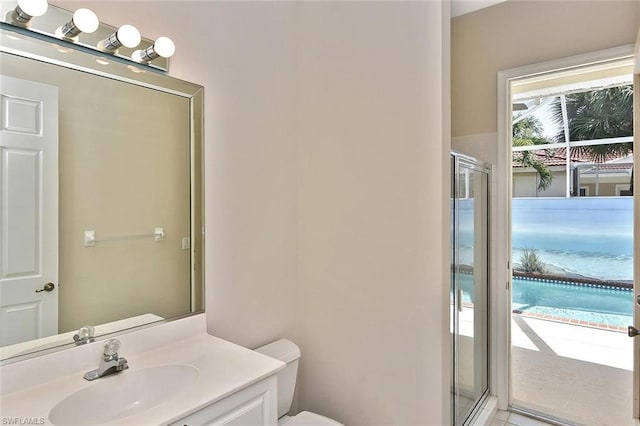 bathroom featuring oversized vanity, toilet, and a shower with shower door