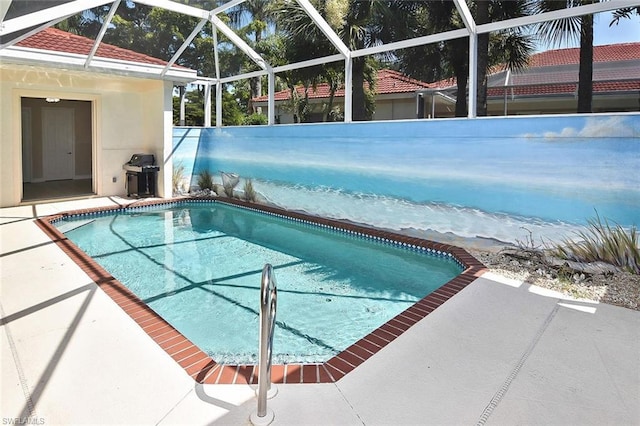 view of pool with area for grilling, a lanai, and a patio