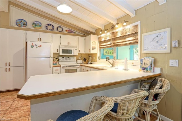 kitchen with white appliances, white cabinetry, vaulted ceiling with beams, and light tile flooring