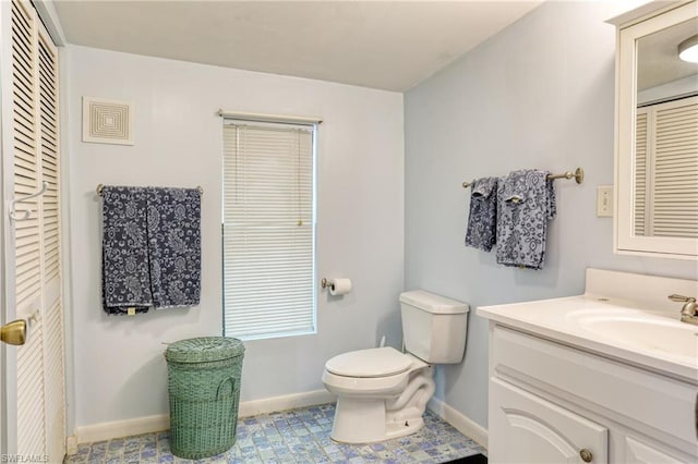 bathroom with toilet, tile floors, and large vanity