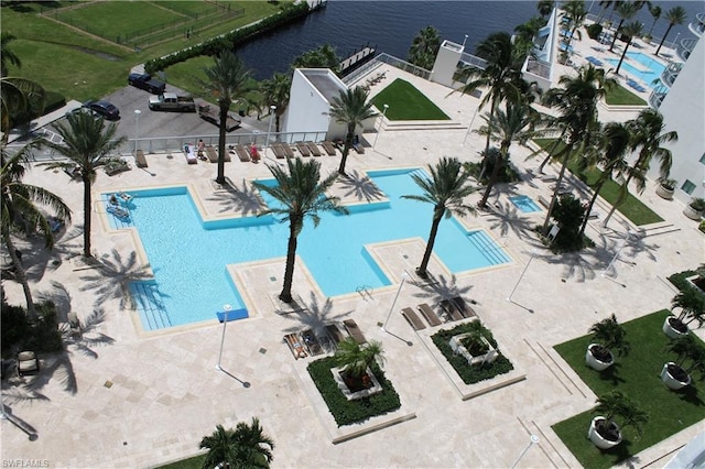 view of pool featuring a patio and a water view