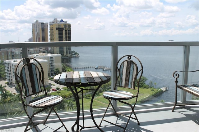 balcony with a water view and central AC unit