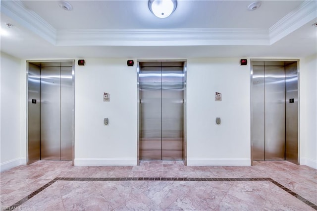 interior space featuring a raised ceiling, multiple closets, light tile floors, and elevator