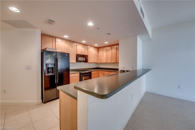 kitchen with kitchen peninsula, black appliances, sink, light tile floors, and light brown cabinetry