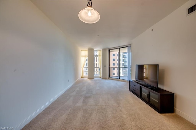 unfurnished living room featuring light colored carpet and floor to ceiling windows