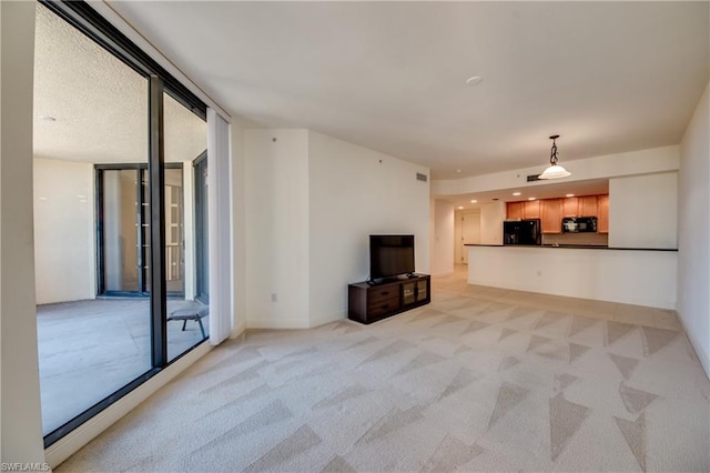 unfurnished living room with floor to ceiling windows and light colored carpet