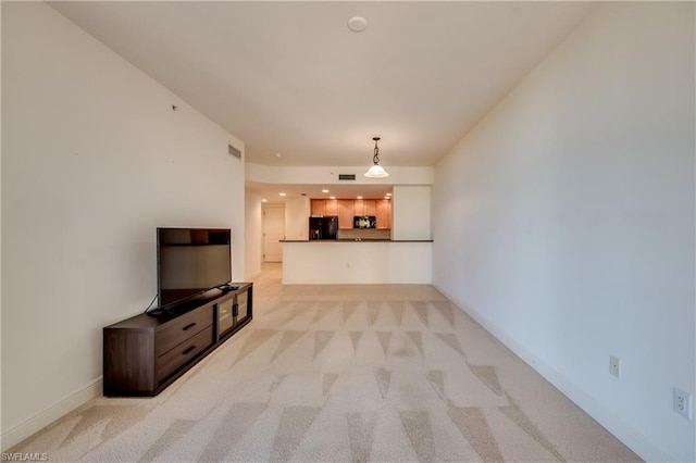 unfurnished living room featuring light carpet