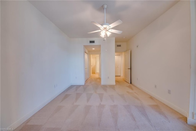 unfurnished bedroom with light colored carpet and ceiling fan