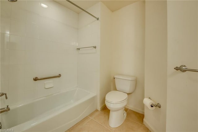 bathroom featuring tiled shower / bath combo, tile flooring, and toilet