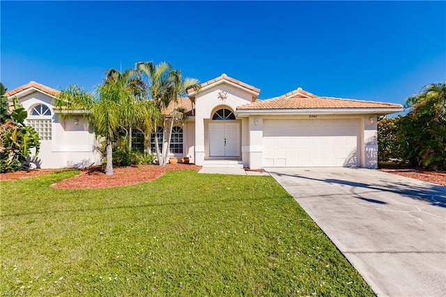 view of front of property with a front lawn and a garage