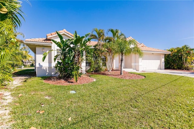 view of front of house with a front yard and a garage